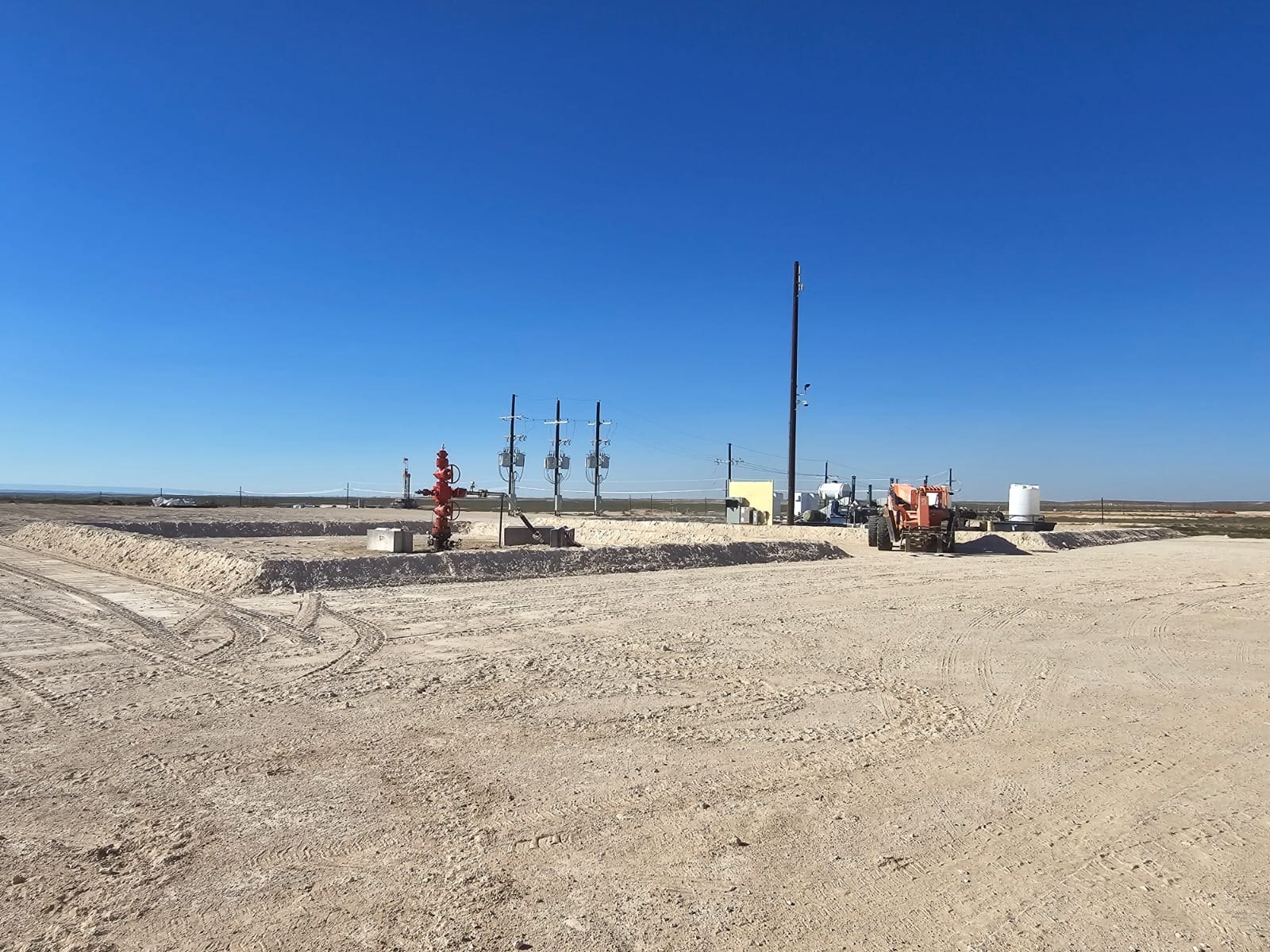oil well site with storage tanks and equipment